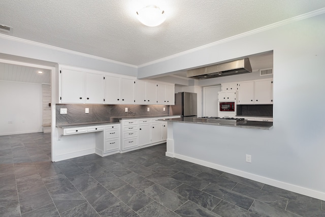 kitchen featuring tasteful backsplash, appliances with stainless steel finishes, a textured ceiling, and white cabinetry