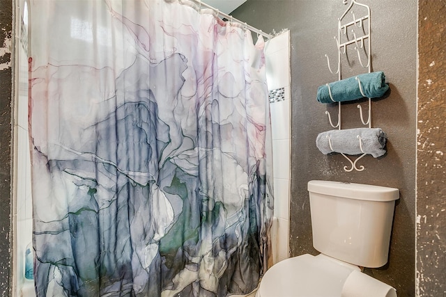 bathroom with toilet and curtained shower