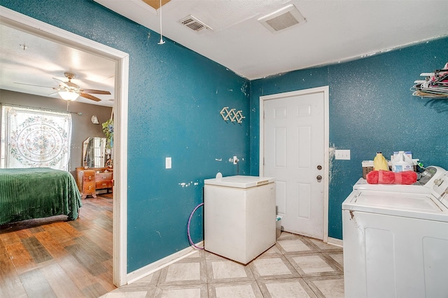 washroom with light wood-type flooring, washer and dryer, and ceiling fan