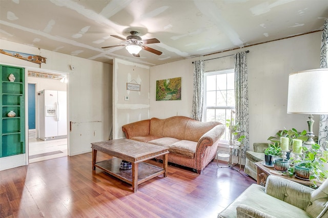 living room featuring ceiling fan and hardwood / wood-style floors