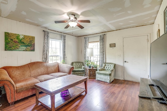 living room featuring wood-type flooring and ceiling fan