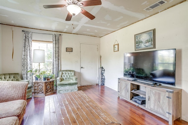 living room featuring wood-type flooring and ceiling fan