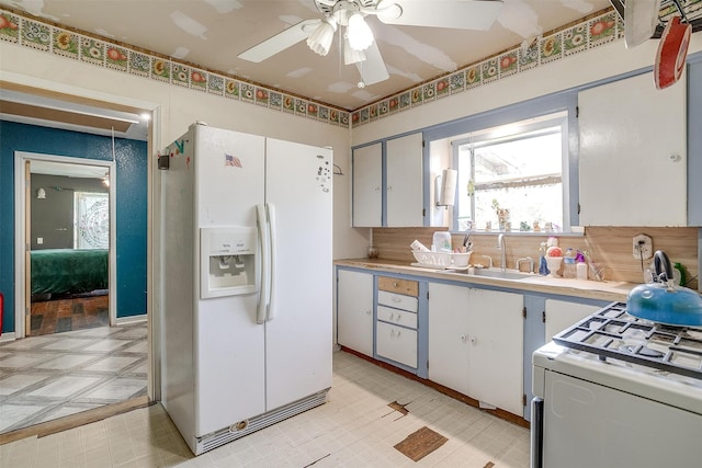 kitchen with ceiling fan, white cabinets, sink, and white appliances