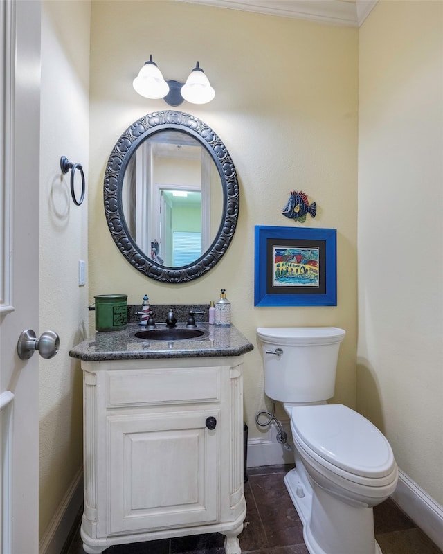 bathroom featuring vanity, crown molding, toilet, and tile patterned floors