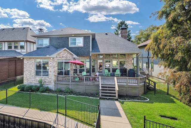 rear view of property with a deck and a lawn