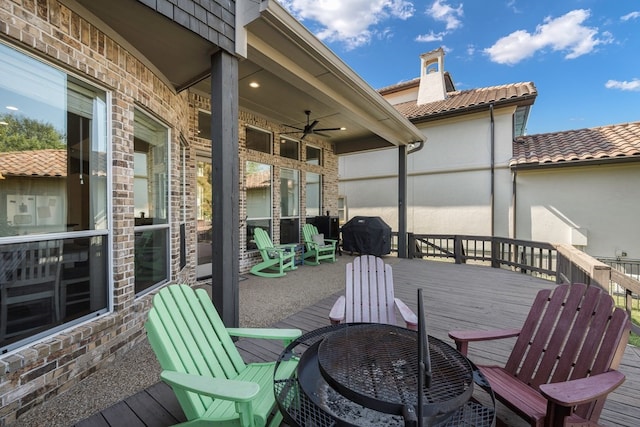 wooden terrace with area for grilling and ceiling fan