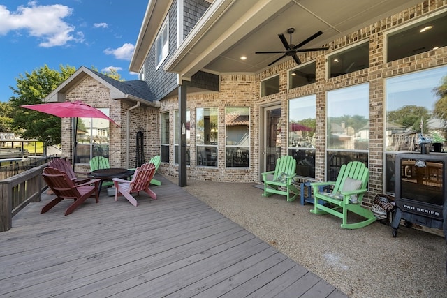 wooden terrace featuring ceiling fan