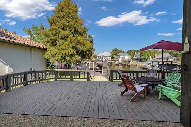 wooden deck featuring a water view