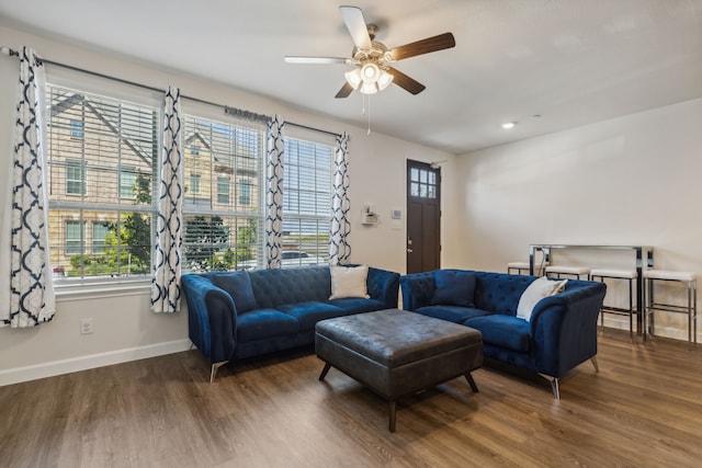 living room with plenty of natural light, dark hardwood / wood-style floors, and ceiling fan