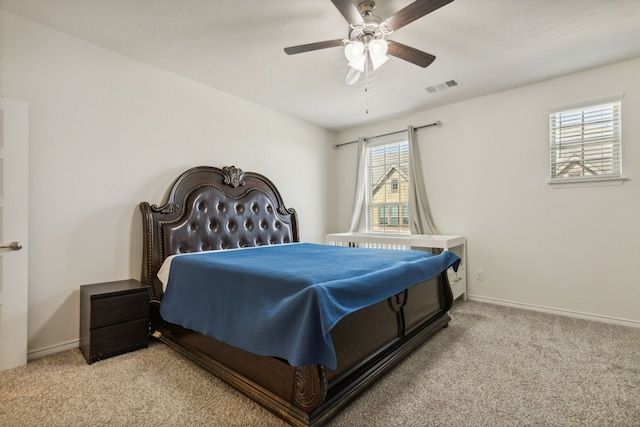 carpeted bedroom featuring multiple windows and ceiling fan