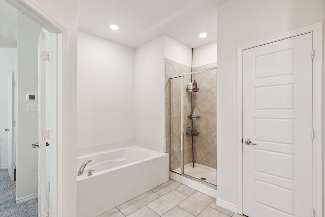 bathroom featuring separate shower and tub and tile patterned flooring