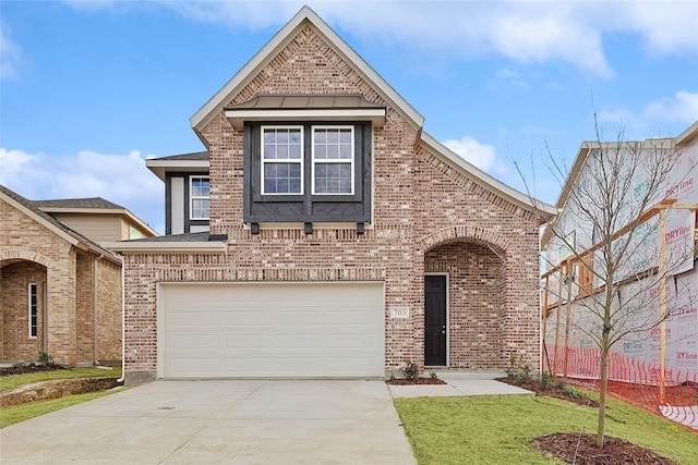 view of front of property with a garage and a front yard