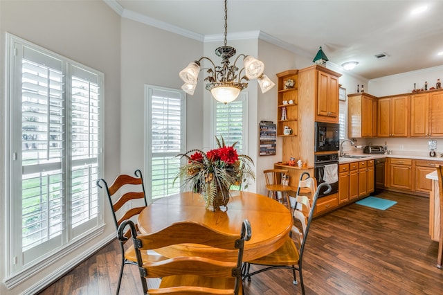 dining space featuring a notable chandelier, dark hardwood / wood-style floors, sink, and a wealth of natural light