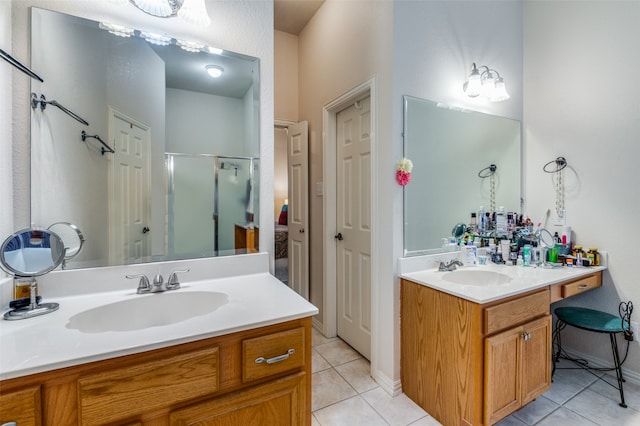 bathroom with tile patterned flooring, vanity, and a shower with door