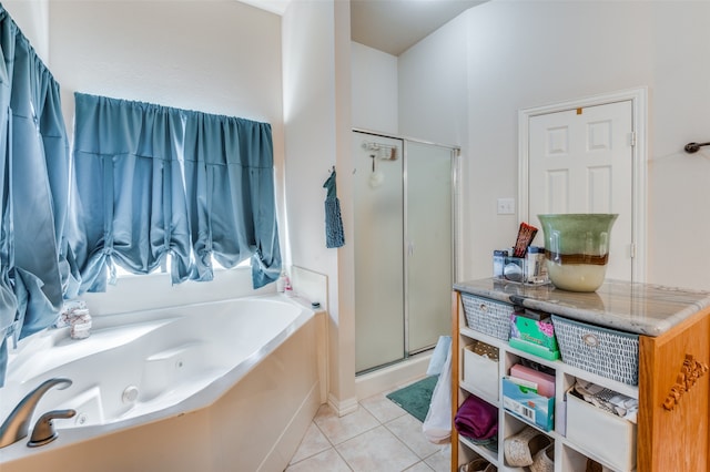 bathroom with separate shower and tub and tile patterned flooring