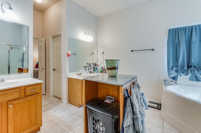 bathroom with tile patterned floors, vanity, shower with separate bathtub, and baseboard heating