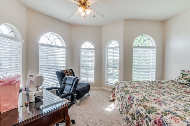 carpeted bedroom featuring multiple windows and ceiling fan