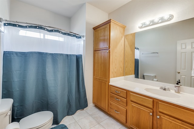 bathroom with tile patterned flooring, vanity, and toilet