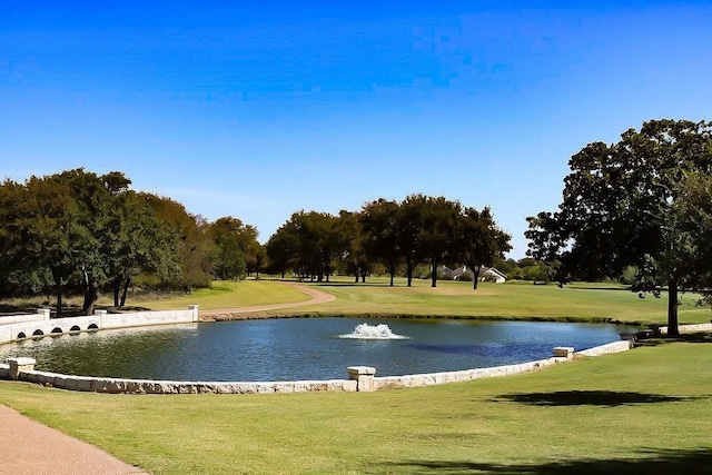 view of community with a water view and a lawn