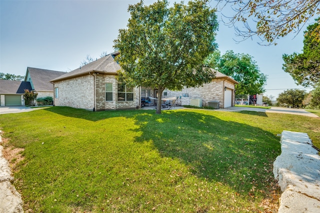 view of front of house with a front yard, a garage, and central air condition unit