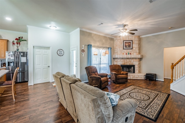 living room featuring a fireplace, dark hardwood / wood-style flooring, ceiling fan, and crown molding