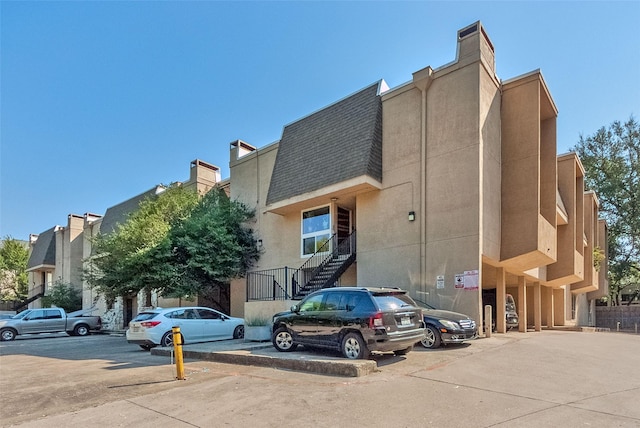 view of property with uncovered parking