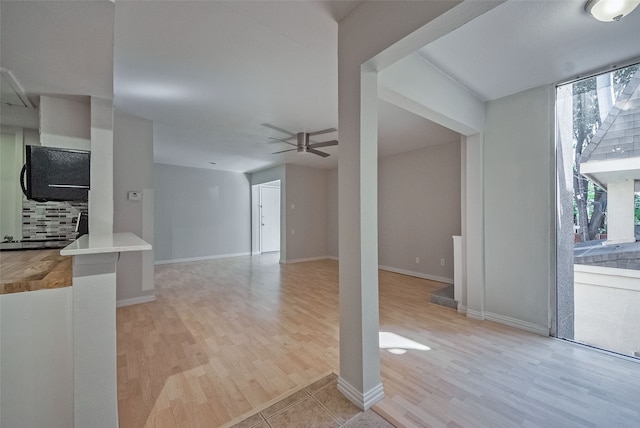 unfurnished living room with ceiling fan and light hardwood / wood-style floors