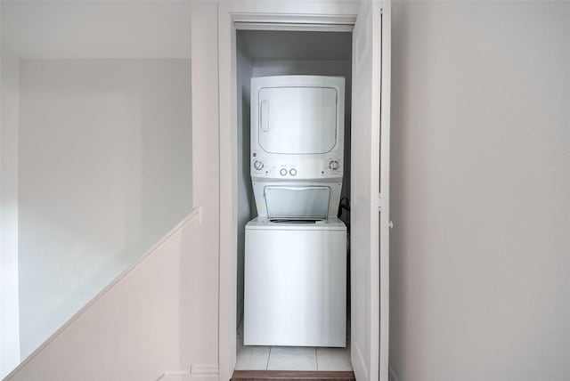 clothes washing area featuring laundry area and stacked washer and clothes dryer