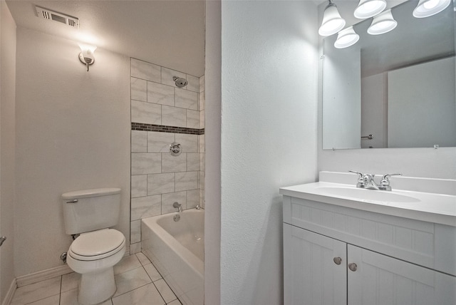 bathroom featuring vanity, visible vents, toilet, tile patterned floors, and baseboards