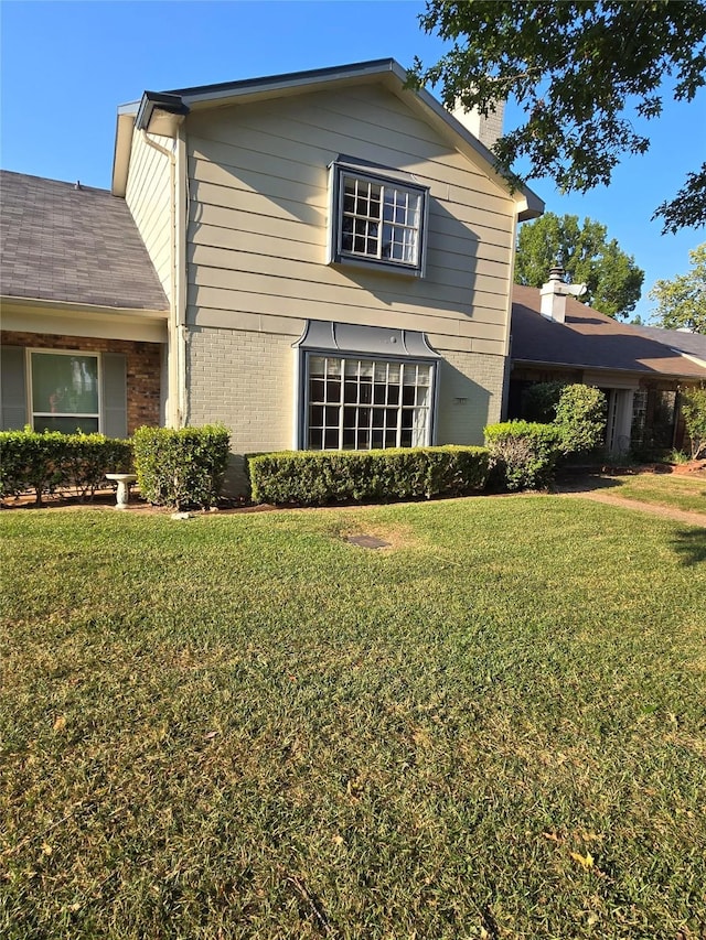 107 Malibu Dr, Shreveport, LA 71115 - view of front of home featuring brick siding, a chimney, and a front yard