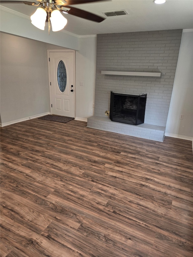 unfurnished living room featuring a brick fireplace, ceiling fan, and dark wood-type flooring