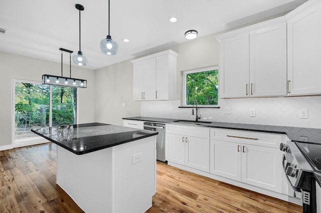 kitchen with white cabinetry, dishwasher, a healthy amount of sunlight, and stove