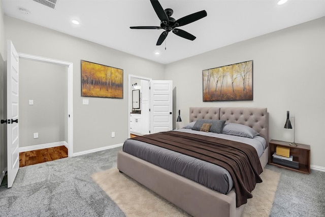 bedroom featuring carpet flooring, ensuite bath, and ceiling fan