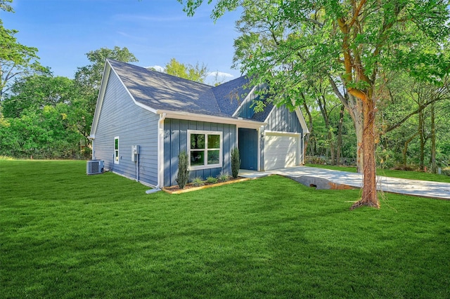 view of front of home featuring central AC unit, a garage, and a front lawn