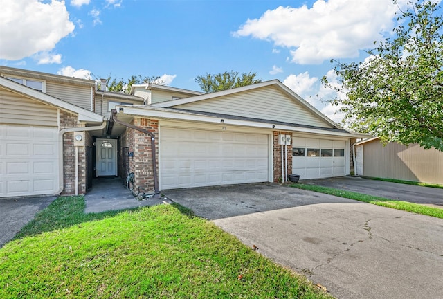 single story home with a garage and a front lawn