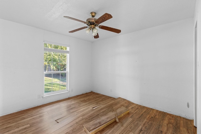 empty room with wood-type flooring and ceiling fan