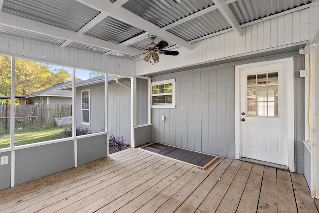 unfurnished sunroom featuring ceiling fan