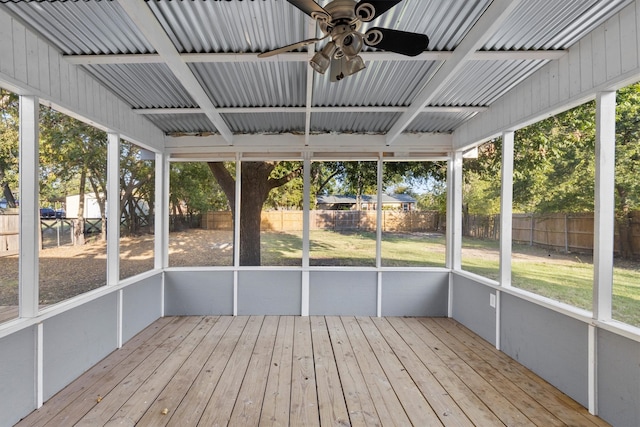 unfurnished sunroom with ceiling fan