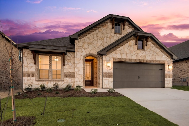 view of front facade with a yard and a garage