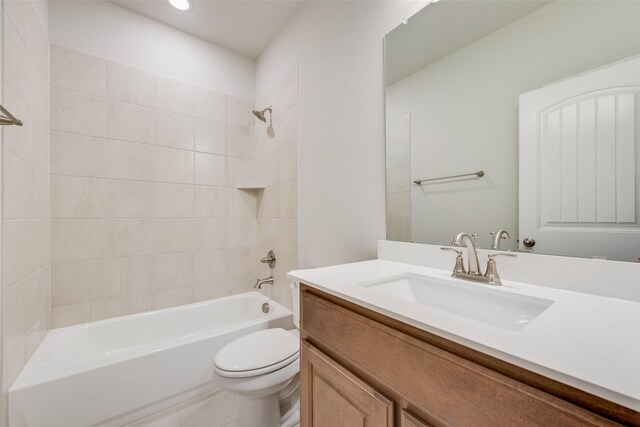 full bathroom featuring tile patterned floors, toilet, vanity, and tiled shower / bath