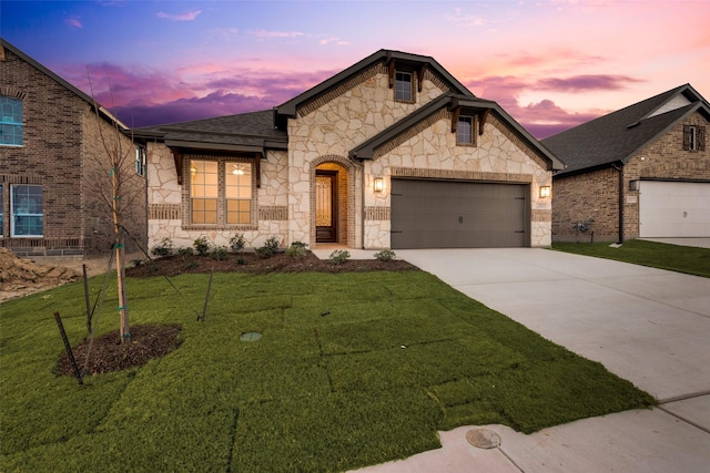 view of front of home with a lawn and a garage