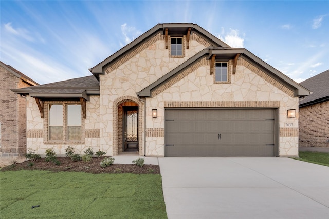 view of front of home with a front lawn and a garage