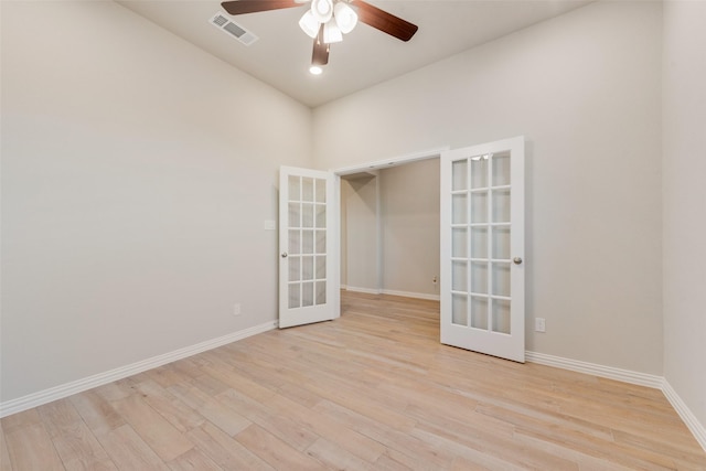 empty room with french doors, light hardwood / wood-style floors, and ceiling fan