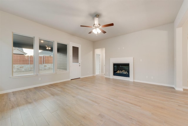 unfurnished living room with light hardwood / wood-style floors and ceiling fan