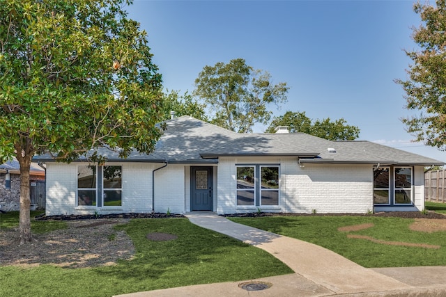 ranch-style home featuring a front yard