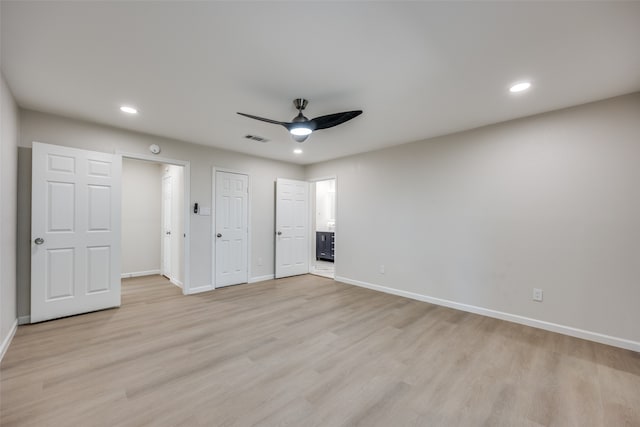 unfurnished bedroom with ensuite bath, light wood-type flooring, and ceiling fan