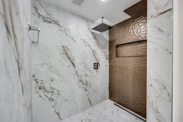 bathroom featuring a tile shower