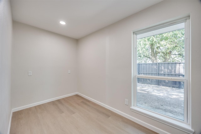 unfurnished room with a healthy amount of sunlight and light wood-type flooring