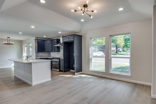 kitchen featuring hardwood / wood-style flooring, backsplash, and a notable chandelier