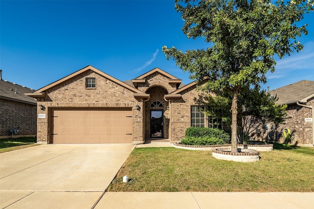 view of front of house featuring a garage and a front lawn